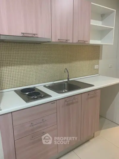 Modern kitchen with sleek cabinetry and gas stove in stylish apartment