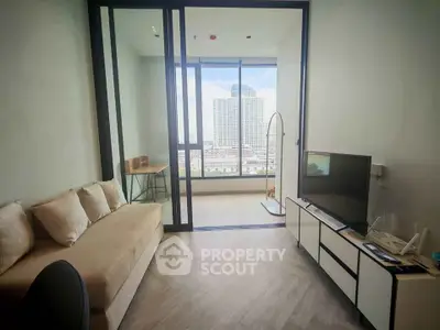 Modern living room with city view, featuring sleek furniture and large windows.