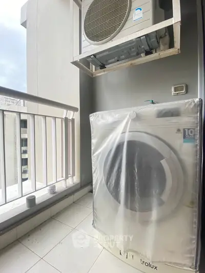 Modern balcony with washing machine and air conditioning unit, ideal for urban living convenience.