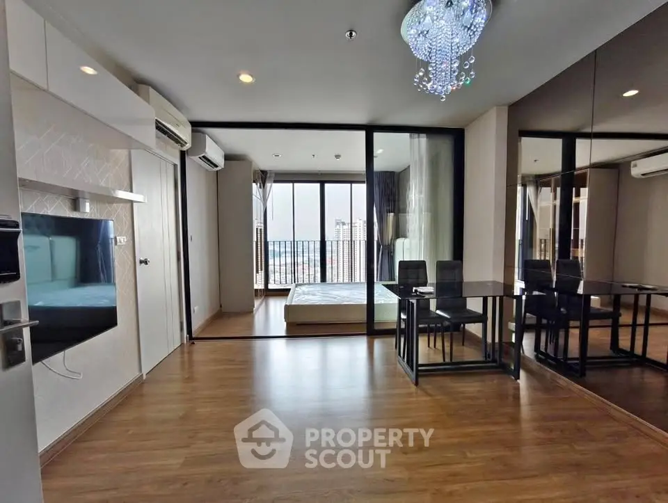 Modern open-plan living room with glass partition and city view balcony