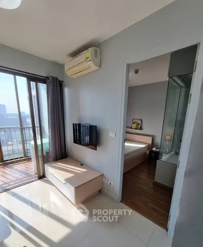 Modern apartment with balcony, air conditioning, and bedroom view, perfect for urban living.