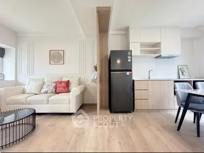 Modern open-plan living room with stylish kitchen and cozy seating area.