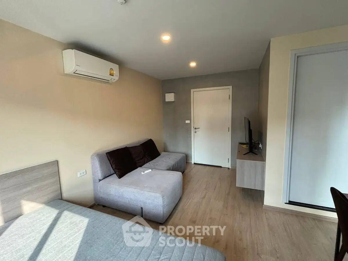 Modern studio apartment with cozy living area and sleek design