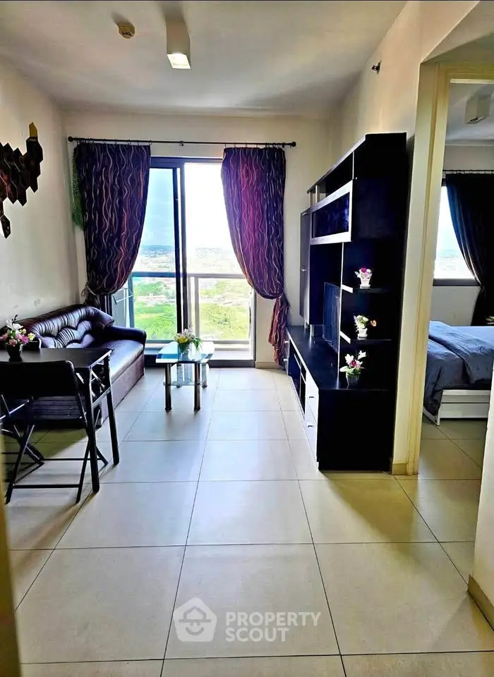 Modern living room with balcony view, stylish furniture, and natural light in a cozy apartment.