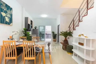 Modern dining area with wooden furniture and open kitchen layout in a stylish home