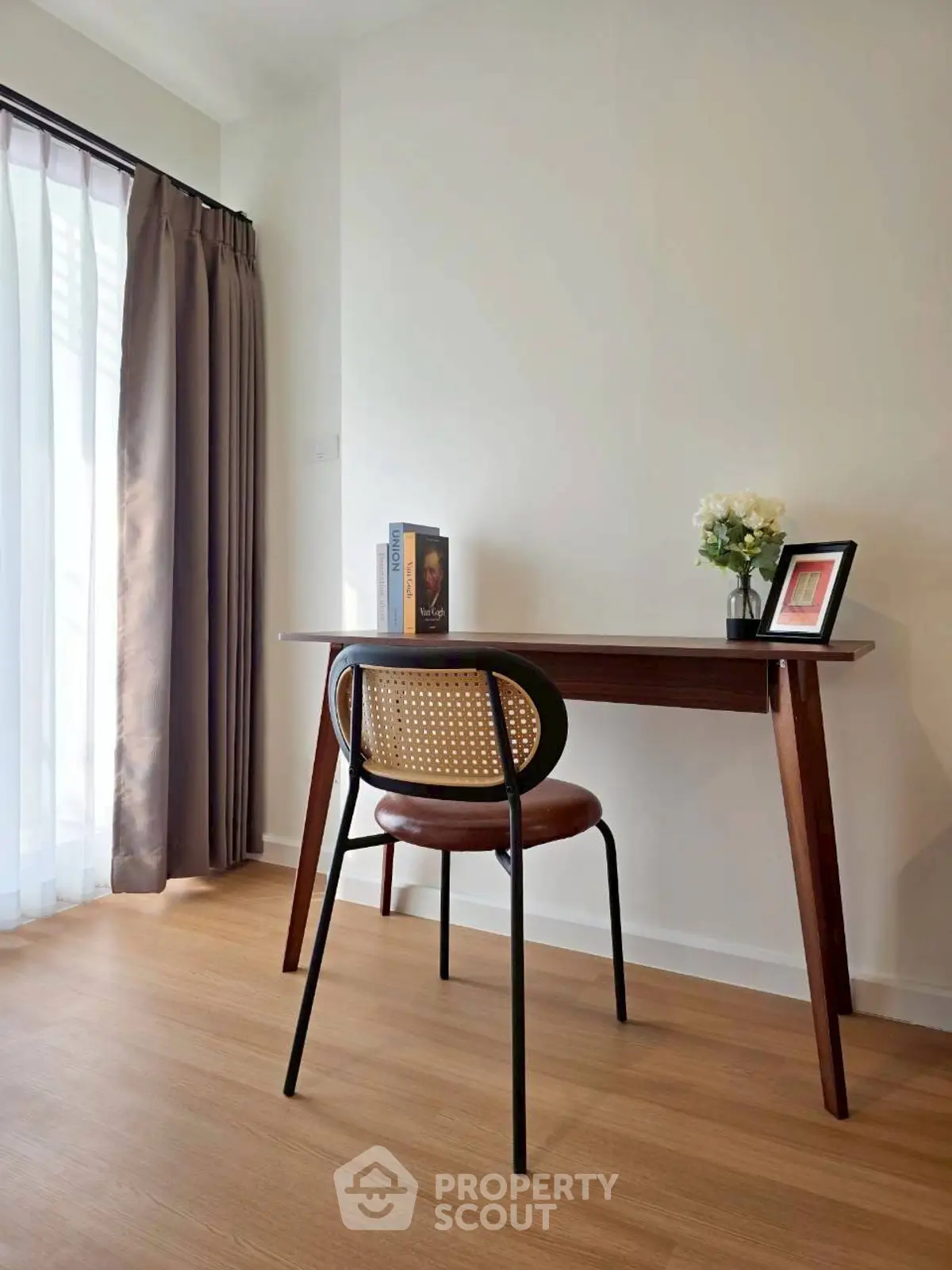 Chic study area with elegant wooden desk and chair, perfect for productivity and style.
