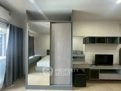Modern bedroom with mirrored wardrobe and sleek furniture design