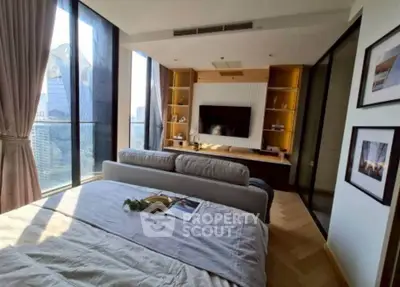 Luxurious bedroom with stunning city view and modern decor in high-rise apartment.
