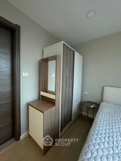 Modern bedroom with sleek wardrobe and cozy bed in stylish apartment