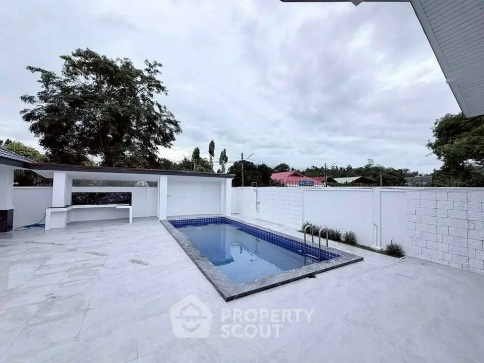 Luxurious outdoor pool area with sleek design and spacious surroundings.