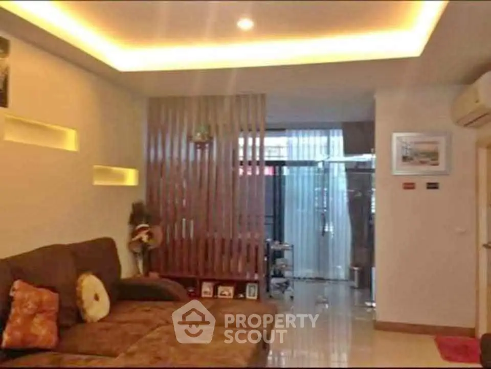 Modern living room with cozy sofa and stylish lighting in a contemporary apartment.