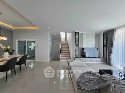 Spacious modern living room with elegant decor and open dining area