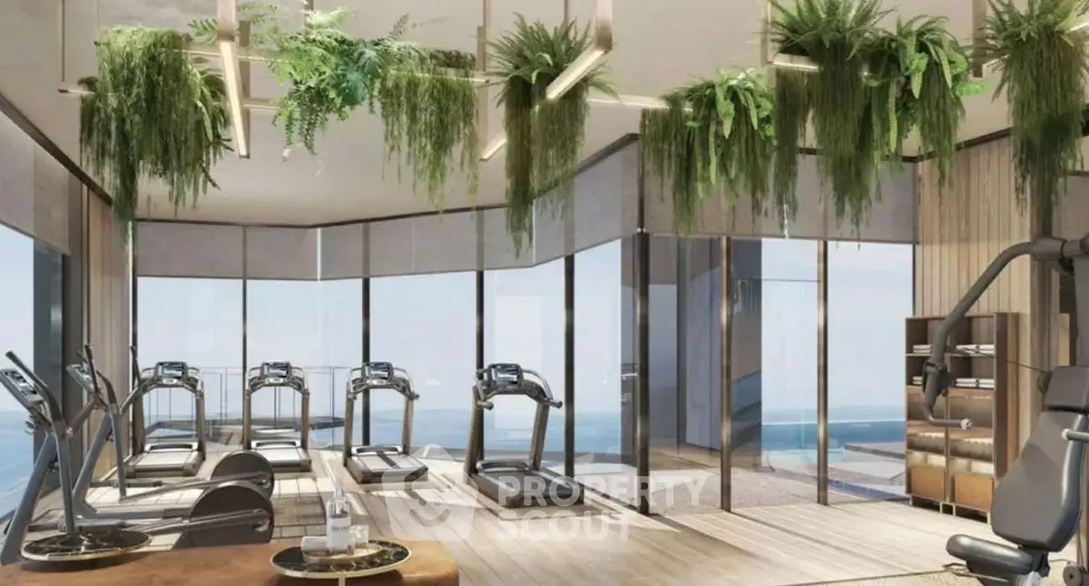 Luxurious gym with panoramic views and modern equipment in high-end residential building.