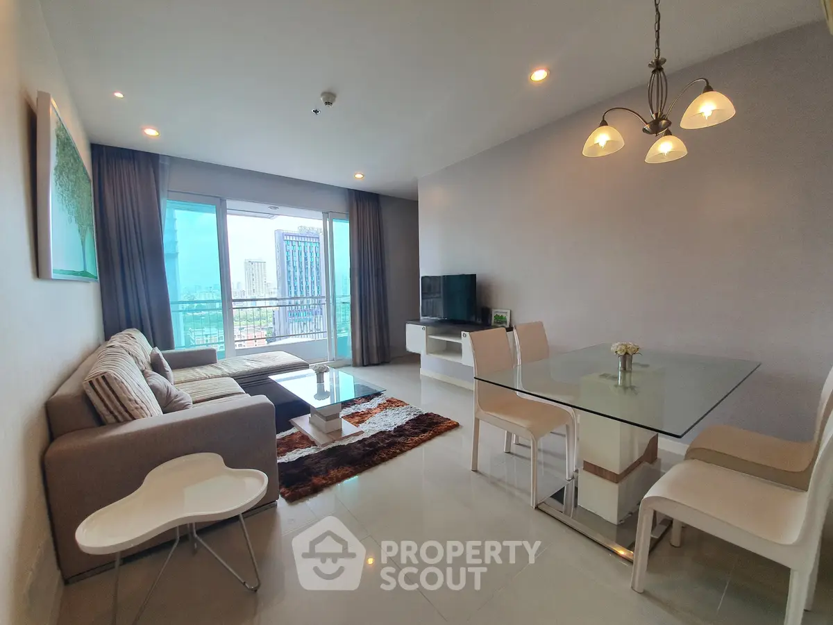 Spacious modern living room with city view, elegant decor, and ample natural light in a high-rise apartment.