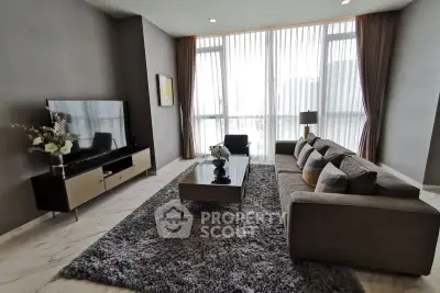 Spacious modern living room with large windows and elegant decor