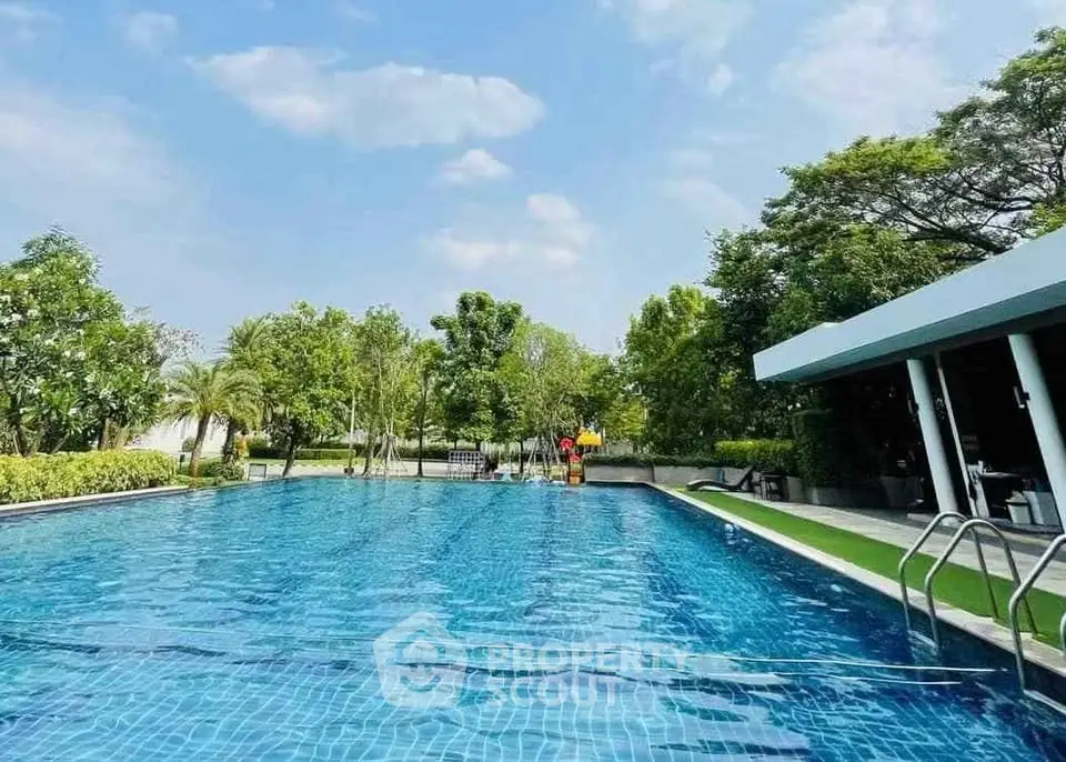 Luxurious outdoor swimming pool with lush greenery and modern amenities