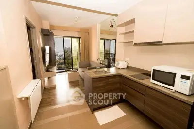 Modern open-layout kitchen and living room with city view balcony
