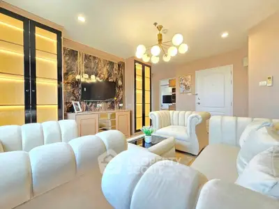 Luxurious living room with elegant white sofas and modern lighting in a stylish apartment.