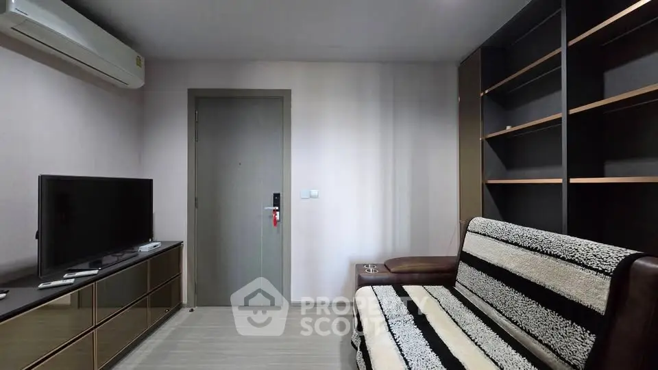 Modern living room with sleek furniture and built-in shelving, perfect for urban living.