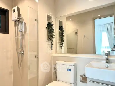 Modern bathroom with sleek fixtures and elegant design, featuring a glass shower and stylish vanity.
