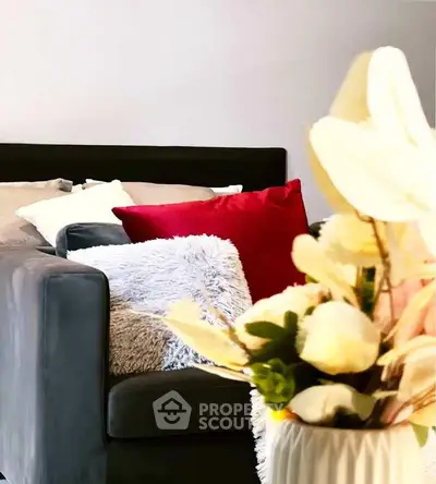 Stylish living room with plush sofa and vibrant cushions, perfect for modern comfort and elegance.