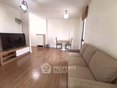 Spacious living room with modern furniture and wooden flooring