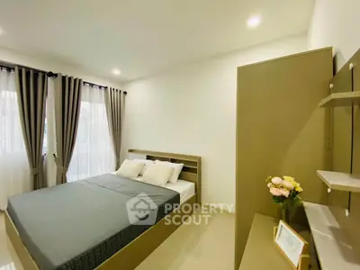 Modern bedroom with stylish decor and ample natural light