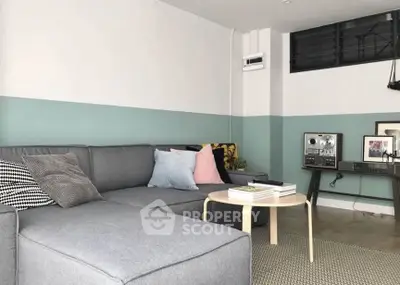 Stylish modern living room with cozy gray sectional sofa and chic decor accents.