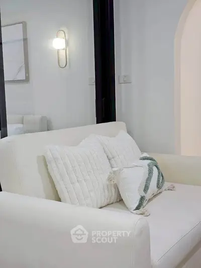 Modern living room with elegant white sofa and stylish decor