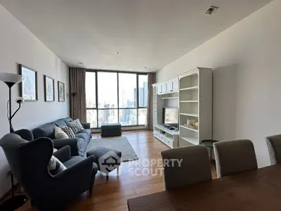 Spacious living room with modern furniture and city view, perfect for urban living.