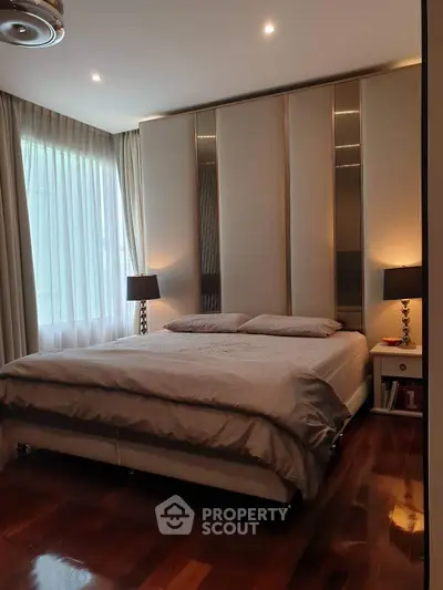 Luxurious bedroom with elegant decor and ample natural light