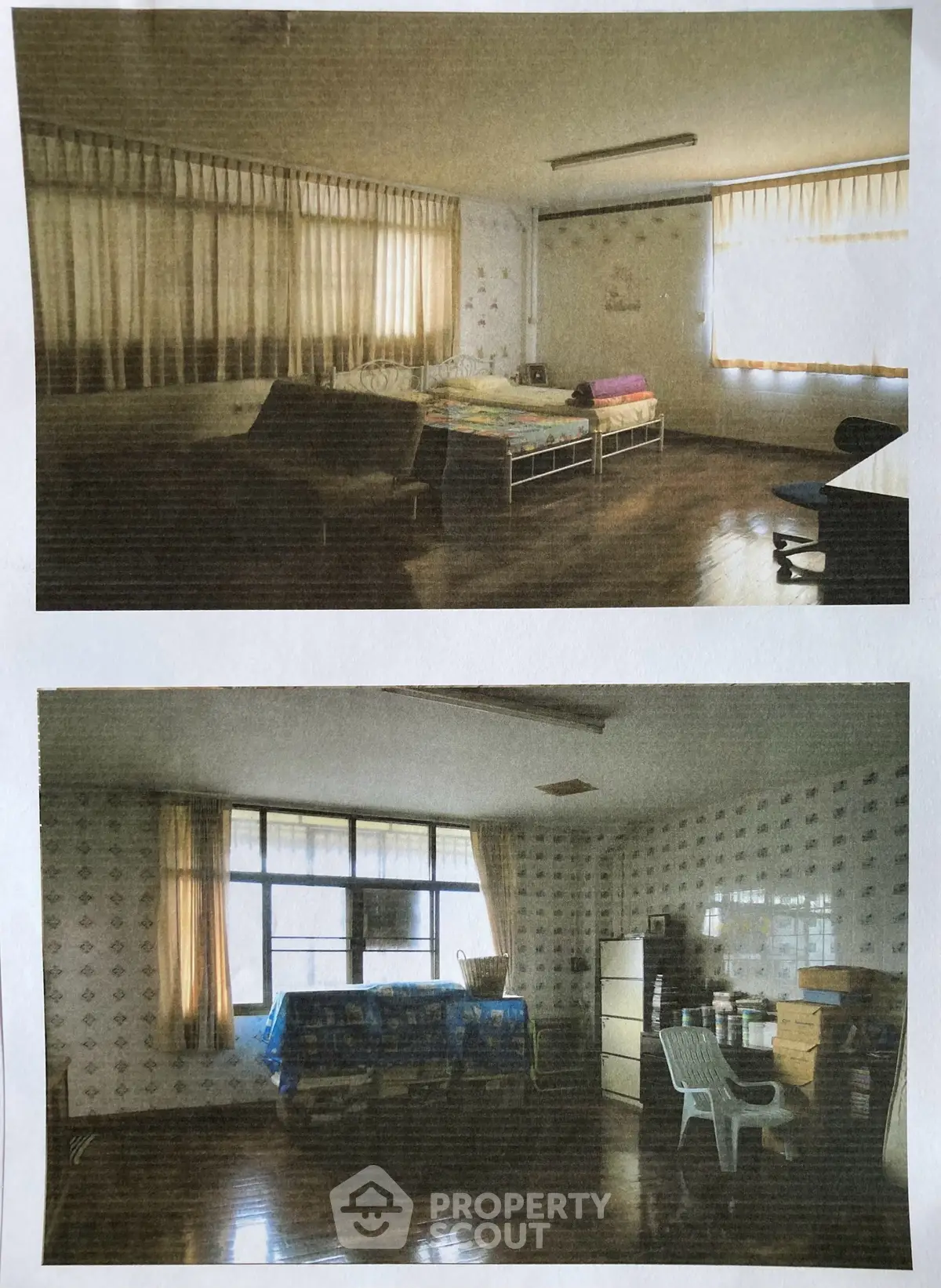 Spacious bedroom with large windows and ample natural light, featuring minimalist furnishings and hardwood floors.