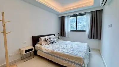 Modern bedroom with stylish lighting and large window in a contemporary apartment.