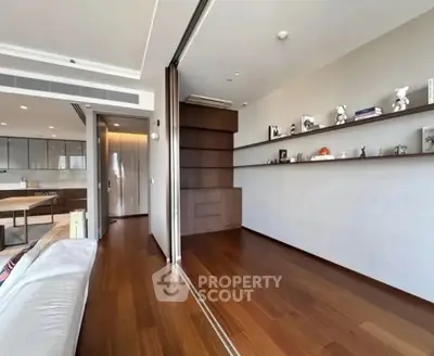 Spacious modern living room with wooden flooring and sliding partition in luxury apartment.