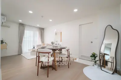 Modern dining area with elegant furniture and natural light in a stylish apartment.