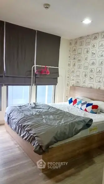 Cozy bedroom with stylish decor and large windows in modern apartment