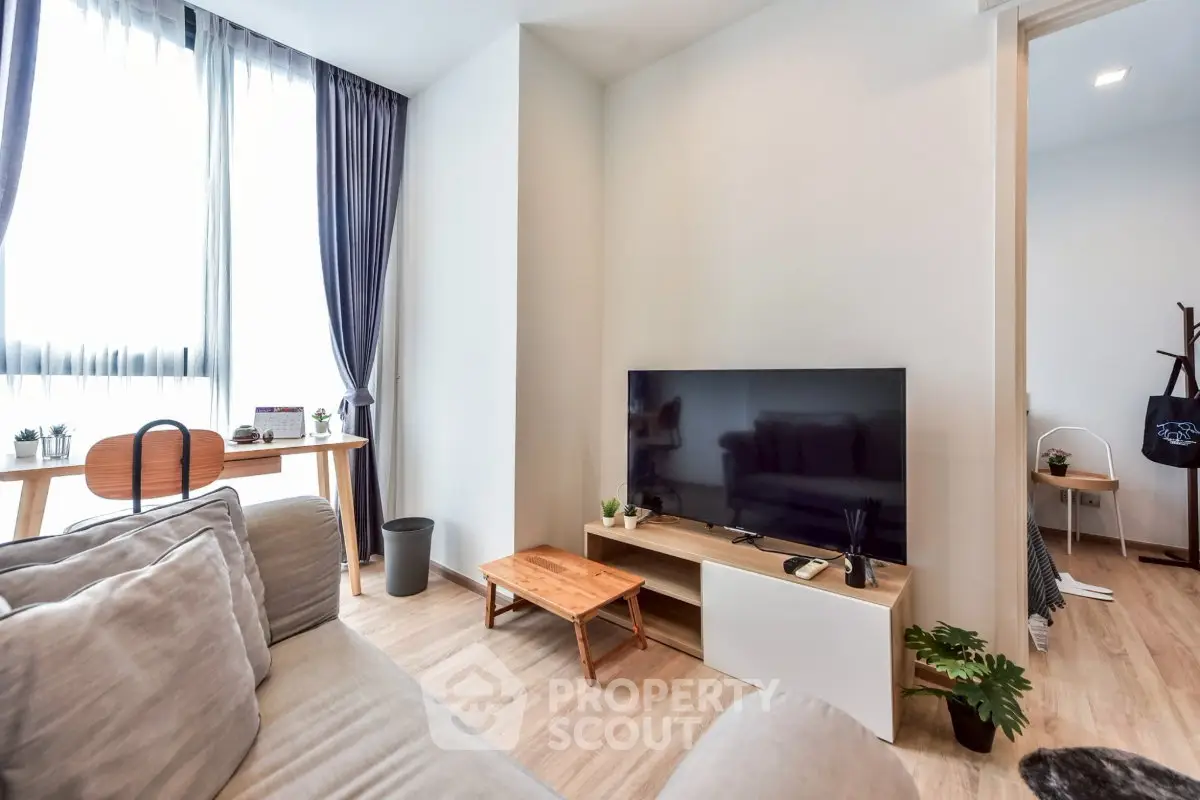 Modern living room with natural light, stylish furniture, and a cozy atmosphere.