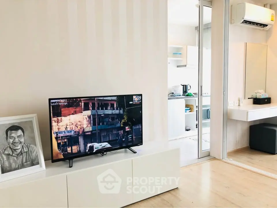 Modern living room with TV and open kitchen in stylish apartment