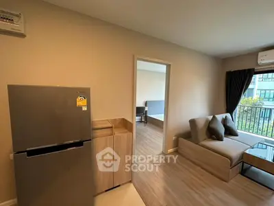 Modern living room with balcony view and sleek kitchen area