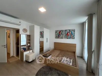 Modern bedroom with stylish decor, featuring a wooden bed frame, mirrored wardrobe, and vibrant artwork.