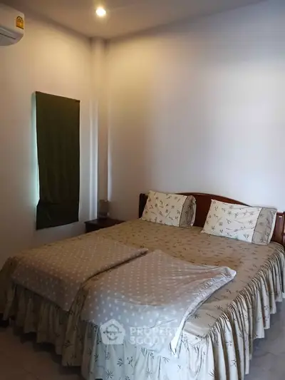 Cozy bedroom with double bed and soft lighting, perfect for relaxation.