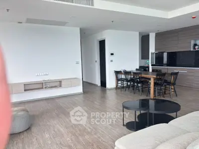 Spacious modern living room with open kitchen and elegant dining area