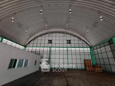 Spacious industrial warehouse with high ceilings and ample storage space.