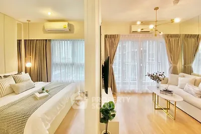 Modern apartment with spacious bedroom and elegant living room, featuring large windows and stylish decor.