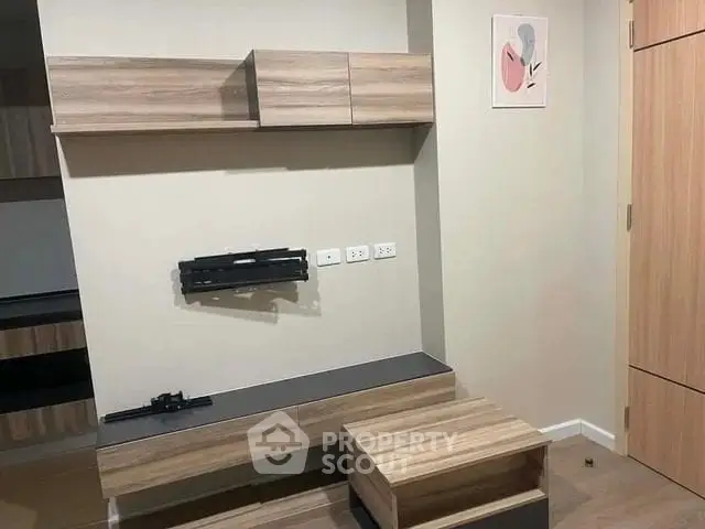 Modern interior with stylish wooden cabinets and neutral wall art in a cozy living space.