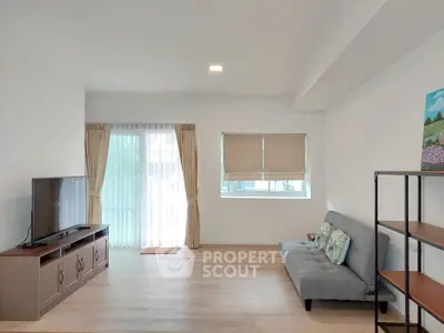 Spacious living room with modern decor and natural light