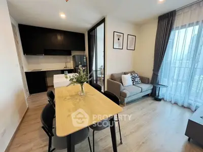 Modern open-plan living room with dining area and kitchen in a stylish apartment