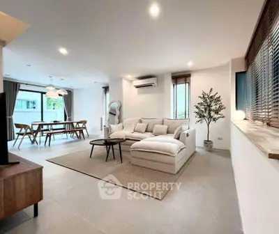 Spacious modern living room with open dining area and stylish decor