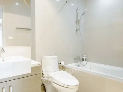 Modern bathroom with sleek fixtures and a bathtub in a contemporary apartment.