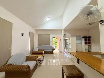 Spacious living room with modern furniture and open layout, perfect for relaxation and entertaining.